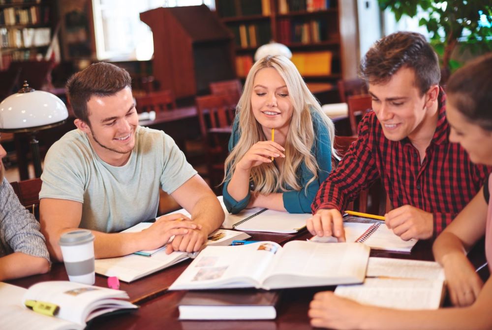 classmates-studying-together-library