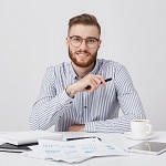 professional-male-worker-with-thick-beard-trendy-hairstyle-wears-round-glasses-formal-shirt1-min-150